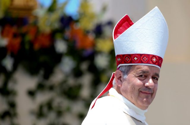 FILE PHOTO: Bishop Juan Barros looks on as Pope Francis leaves at the end of a mass at the Lobito beach in Iquique